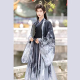 Men’s Martial Arts Hanfu outfit featuring a cross collar design, traditional ink motifs, and flowing sleeves.
