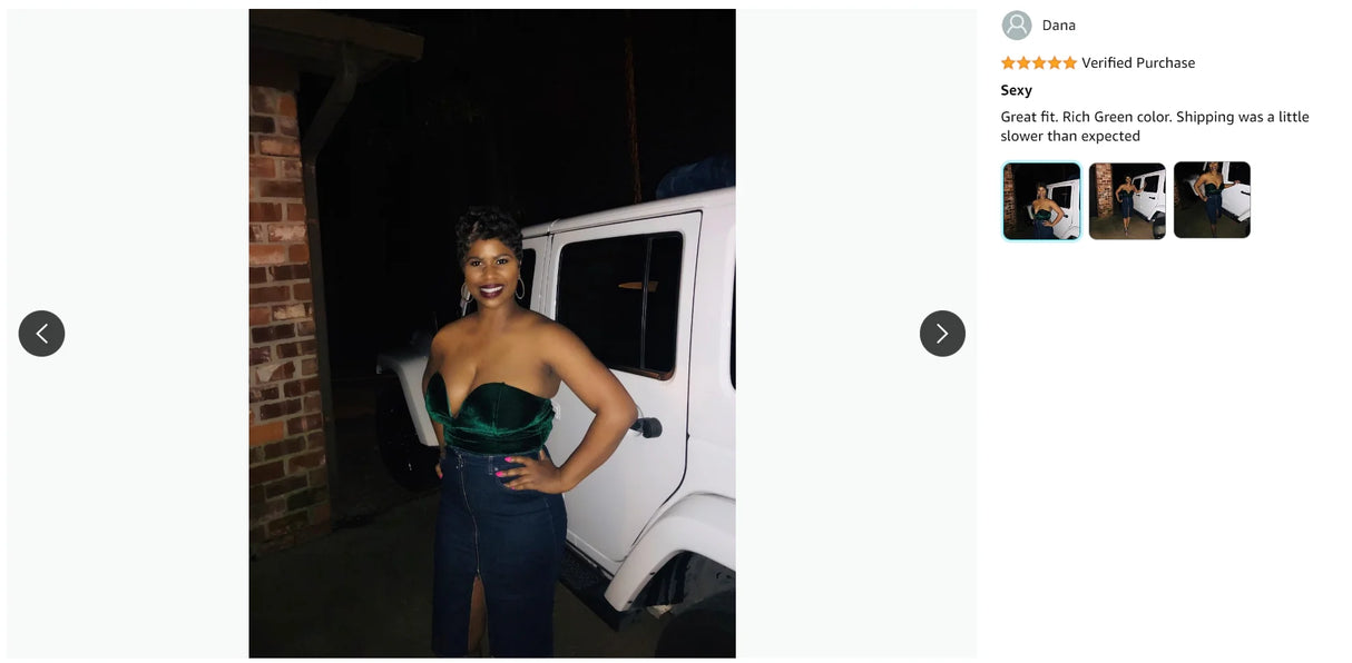 Woman in a rich green strapless bodysuit posing confidently next to a white vehicle at night.