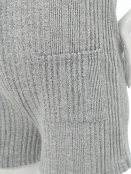 Close-up of a sleeveless ribbed maternity jumpsuit showing textured fabric and side pockets in gray.