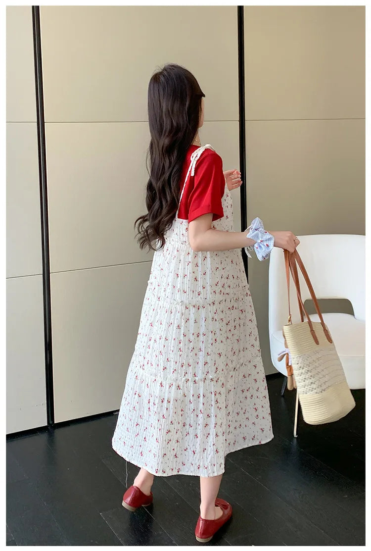 Woman wearing a floral two-piece maternity skirt with contrasting colors, seen from the back in a stylish indoor setting.