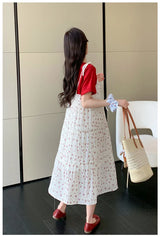 Woman wearing a floral two-piece maternity skirt with contrasting colors, seen from the back in a stylish indoor setting.
