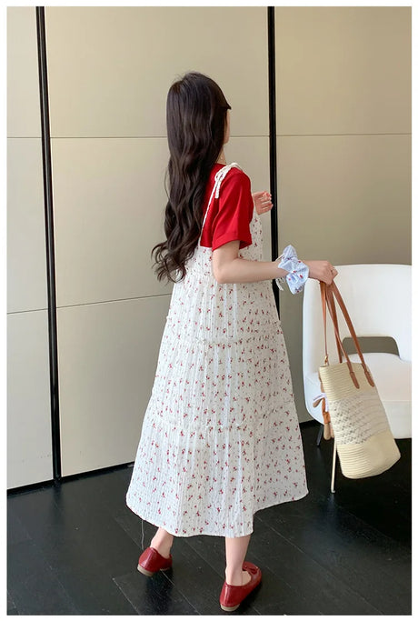Woman wearing a floral two-piece maternity skirt with contrasting colors, seen from the back in a stylish indoor setting.