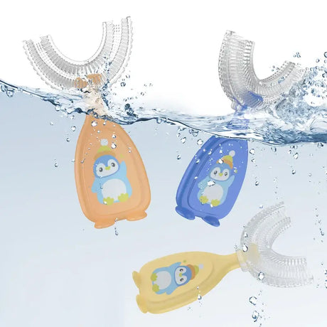 Three penguin-themed baby toothbrushes submerged in water, showcasing vibrant colors and soft silicone design for toddlers.