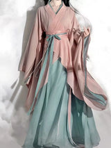Elegant vintage Hanfu dress in soft pink and turquoise, showcasing flowing fabric and traditional design for women.