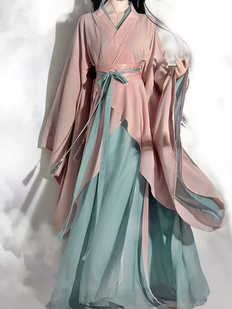 Elegant vintage Hanfu dress in soft pink and turquoise, showcasing flowing fabric and traditional design for women.