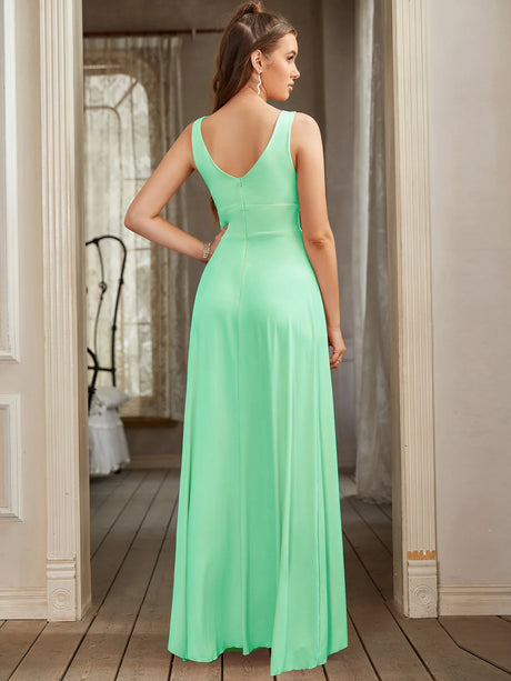 Back view of a mint green bridesmaid evening gown with a V-neck and flowing A-line silhouette.