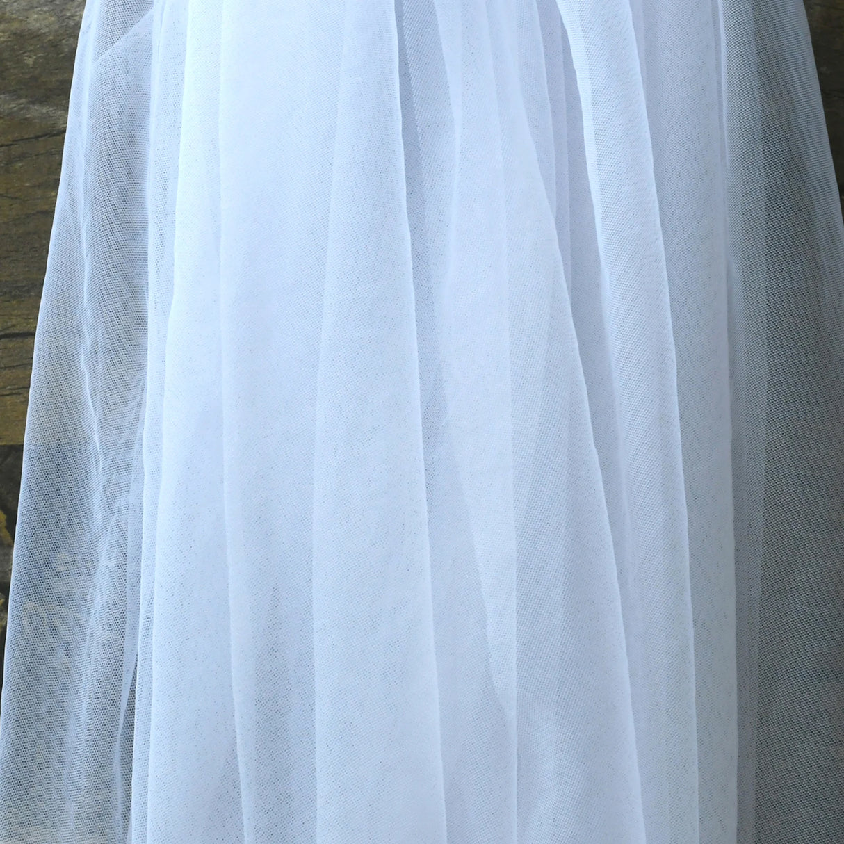 VG73 sheer wedding jacket fabric close-up, lightweight white tulle for bridal wear.