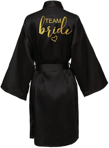 Black satin kimono robe with gold 'TEAM Bride' lettering, perfect for bridal parties and celebrations.