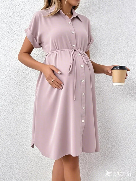 Styled striped button shirt maternity dress in soft pink, perfect for casual summer outings, designed for expectant mothers.