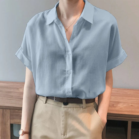 Light blue oversized summer blouse with button-down closure and turn-down collar, styled for a relaxed fit.
