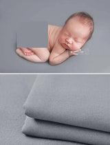 Newborn soft wrap blanket in light gray, perfect for newborn photography and cozy cuddles.