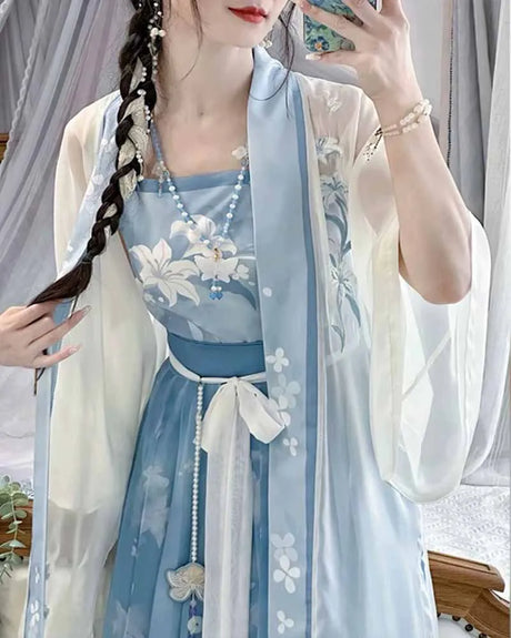 Model wearing a vintage light-blue plus size Hanfu dress with floral patterns and elegant sleeves.