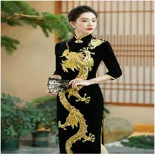 Elegant woman in a black Chinese cheongsam with gold dragon embroidery, showcasing traditional fashion.