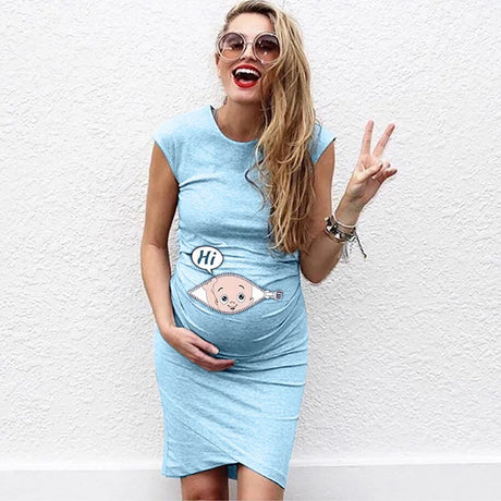 Smiling pregnant woman in blue loose casual maternity dress, featuring cartoon design on belly, perfect for summer wear.