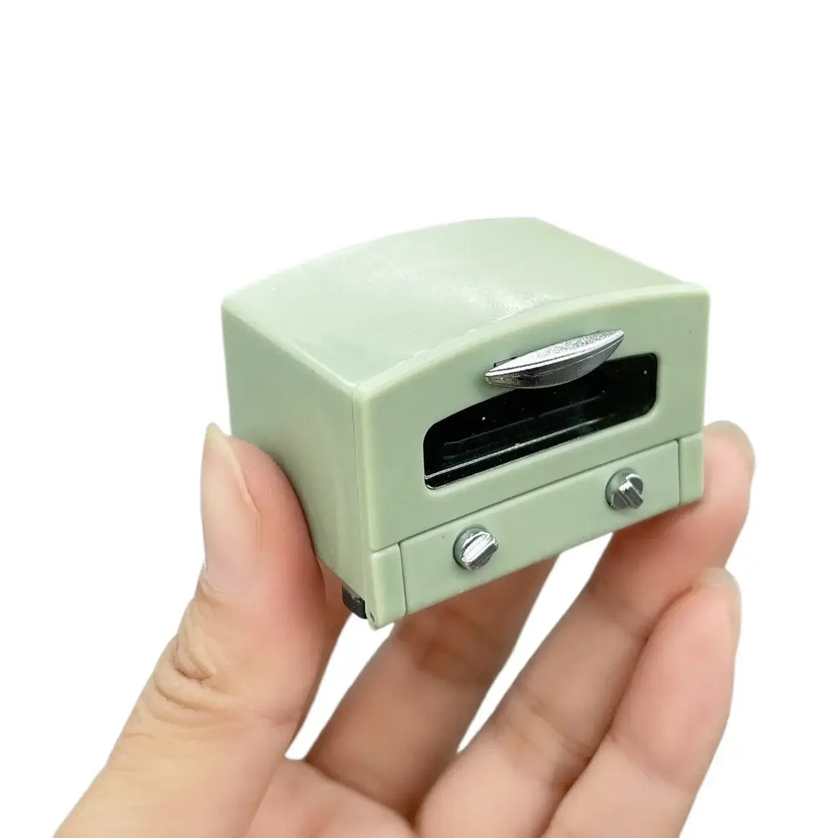 Miniature vintage green oven model held in hand, perfect for newborn baby photography props.