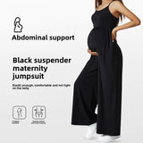 Black suspenders maternity jumpsuit featuring abdominal support, elastic fit, and comfortable design for expecting mothers.