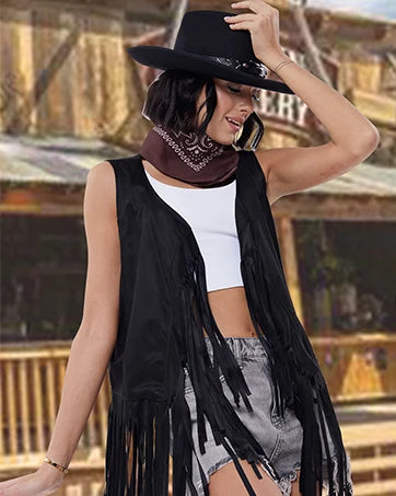 Woman wearing a black cowboy costume with a tassel vest, hat, and bandana in a Western-themed setting.