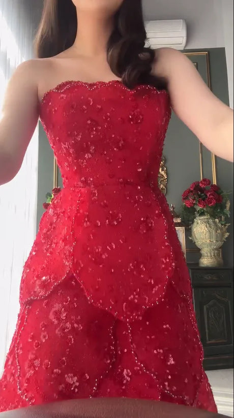Red strapless beaded dress shown from waist up, featuring a textured sequined design, perfect for special occasions.