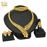 Luxury Indian bridal jewelry set featuring a 24K gold plated necklace, earrings, ring, and bracelet.