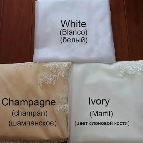 Three fabric samples showing White, Champagne, and Ivory colors for wedding dresses with decorative lace.