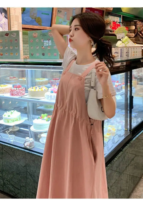 Korean loose fit maternity dress in pink, perfect for holiday photography and casual outings, styled with a simple top.