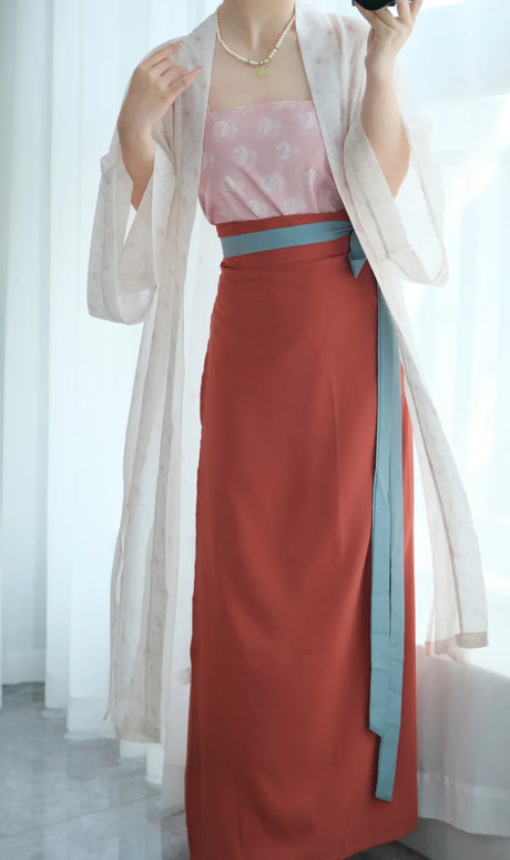 Woman modeling a Song Dynasty Hanfu retro three-piece outfit with pink top and red skirt, showcasing traditional Chinese fashion.