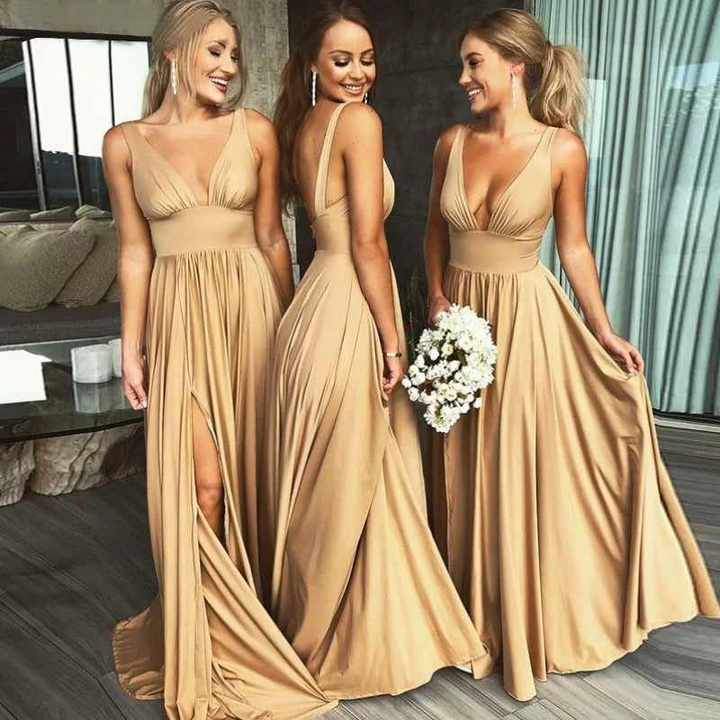 Three women in elegant V-neck split bridesmaid dresses in beige, showcasing a floor-length A-line silhouette.