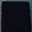 Black fabric roll, ideal for various sewing projects and garment making.