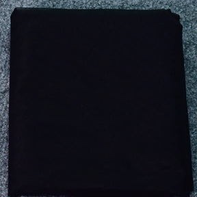 Black fabric roll, ideal for various sewing projects and garment making.
