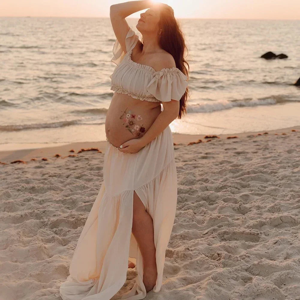 Boho two-piece maternity set on a beach at sunset, perfect for photoshoots and baby showers.