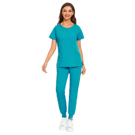 Model wearing 7-color nursing work uniform with zipper v-neck top and pants in vibrant turquoise.