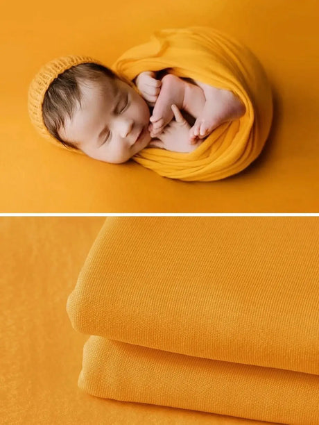 Newborn soft wrap blanket in bright yellow, perfect for photography and cozy comfort, featuring a sleeping baby.