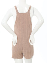 Back view of a sleeveless ribbed maternity jumpsuit in soft pink, showcasing casual overall design for summer.