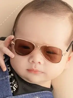 Adorable baby wearing stylish sunglasses, perfect for newborn photography and accessories, showcasing round and heart shapes.