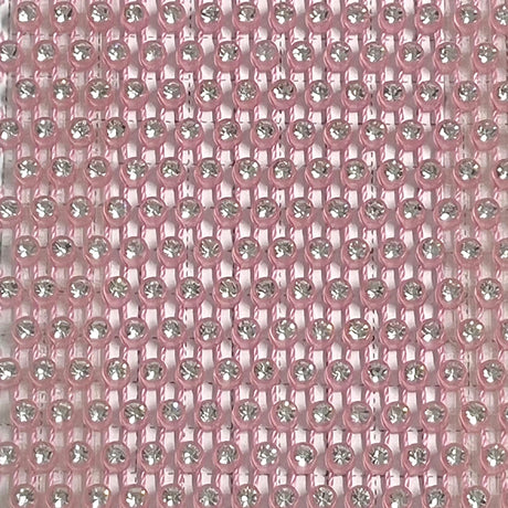 Close-up of shimmering pink mesh fabric with rhinestones, ideal for glamorous party wear.