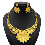 Luxury Indian bridal jewelry necklace set with elegant leaf design in gold, featuring matching earrings for weddings.
