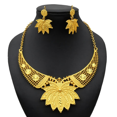Luxury Indian bridal jewelry necklace set with elegant leaf design in gold, featuring matching earrings for weddings.