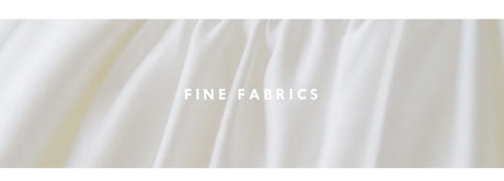 Close-up of fine white fabrics showcasing texture and quality, ideal for elegant clothing and wedding dresses.