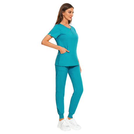 7-color nursing uniform set in turquoise featuring a zipper V-neck top and matching pants with pockets.