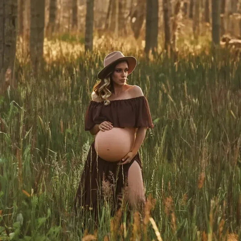 Pregnant woman in a boho two-piece maternity set posing in a field during a photoshoot.