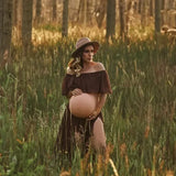 Pregnant woman in a boho two-piece maternity set posing in a field during a photoshoot.