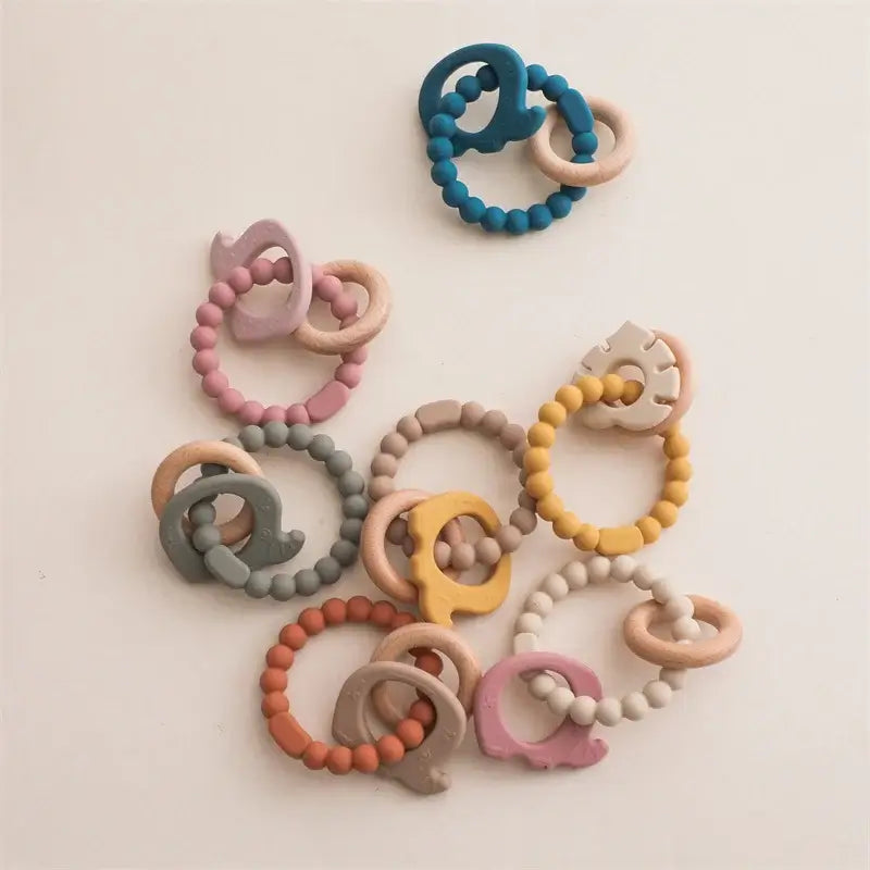 Colorful silicone baby teether gloves in various shades, designed for soothing teething pain in infants and toddlers.