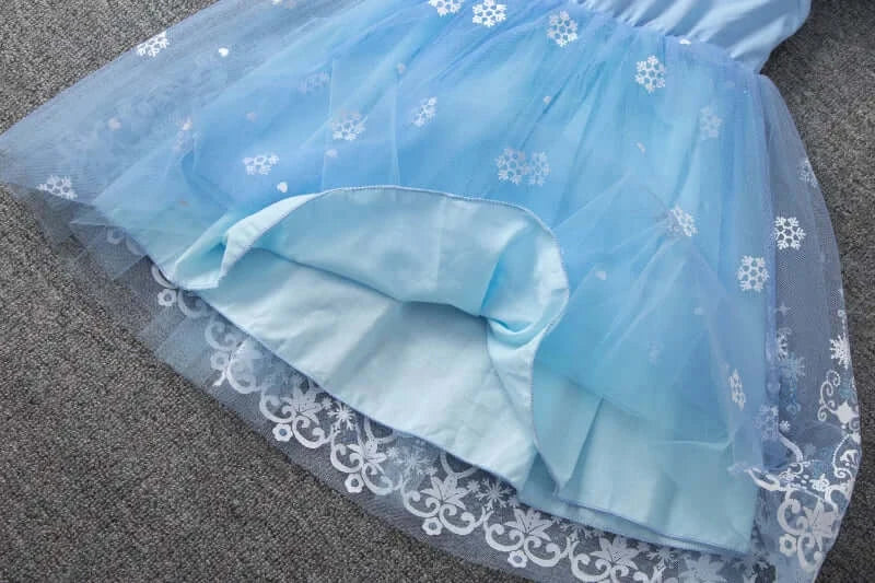 Light blue girls summer dress with flying sleeves, featuring snowflake details and a knee-length tulle skirt.