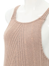 Close-up of sleeveless ribbed maternity jumpsuit fabric in neutral color, showcasing soft texture and comfortable fit.