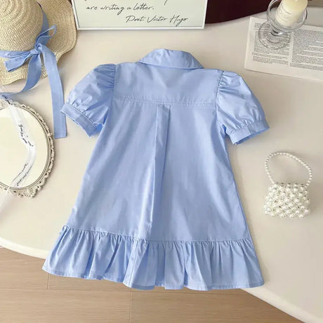 Girls summer dress in light blue with turn-down collar and ruffled hem, perfect for ages 4-6 years.