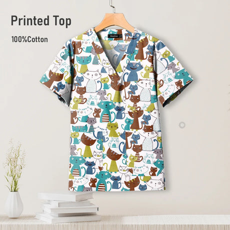 Pediatric hospital surgical scrub top featuring colorful cat print, made from breathable 100% cotton.