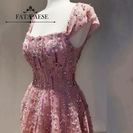 Fully crystal embellished pink wedding gown with beading and sequined details.