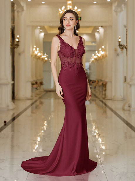 Elegant burgundy mermaid dress featuring intricate lace embellishments and a flattering fit.