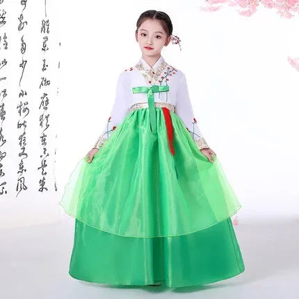 Girl dressed in a beautiful green Korean Hanbok, featuring a layered skirt and traditional detailing.