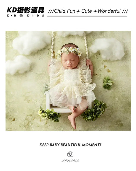 Baby girl in a floral headband swinging in a cloud-themed nursery for newborn photography.